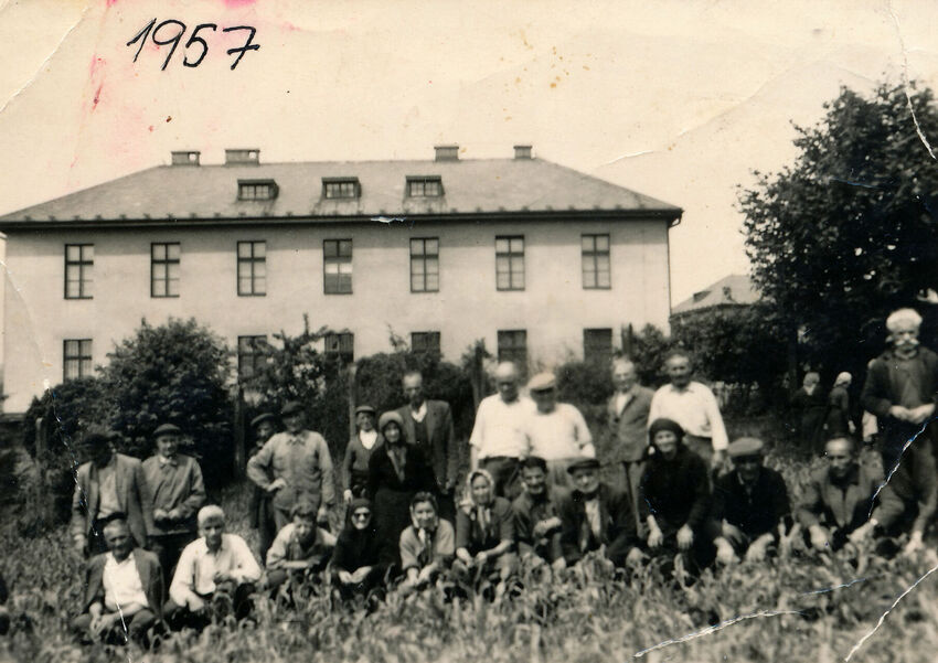 Řečtí uprchlíci před kasárnami v Těchoníně, které se staly jejich domovem (1957). Zdroj: archiv pamětníka